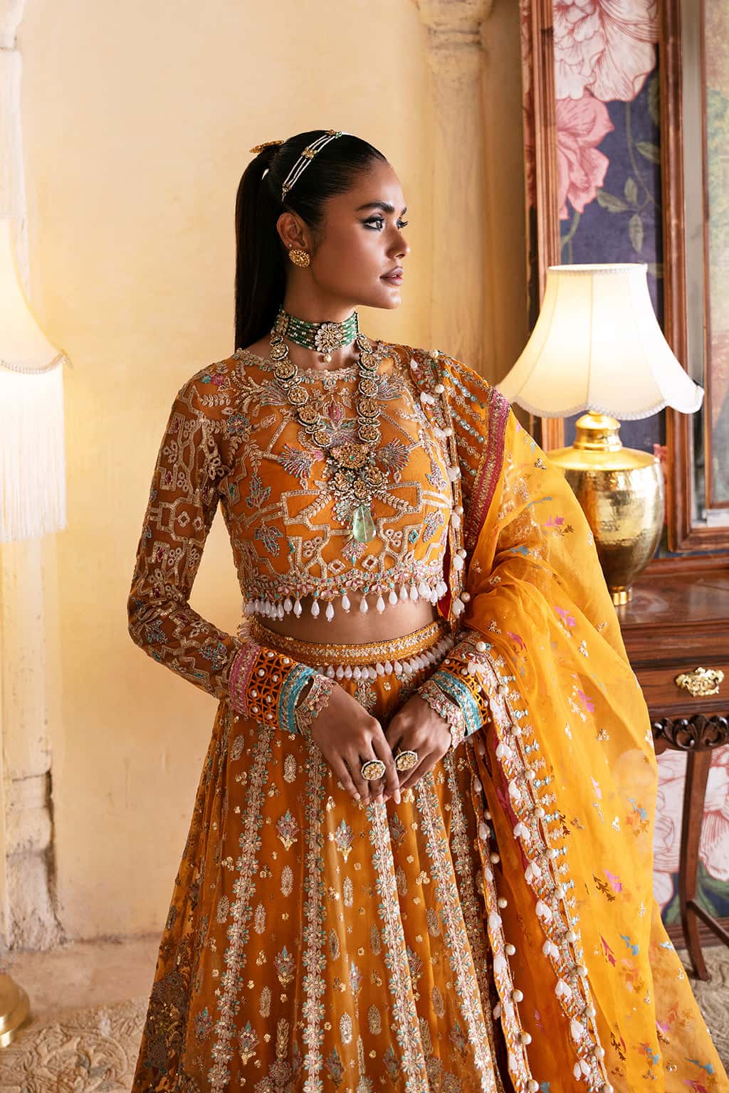 Close-up of antique gold and silver floral embroidery on Afrozeh Kamila mustard yellow organza choli with decorative detailing