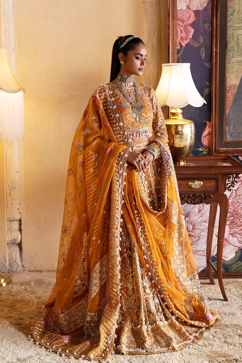 Afrozeh Kamila luxury mustard yellow Pakistani Mehndi lehenga choli with embroidered full sleeves and flowing organza skirt