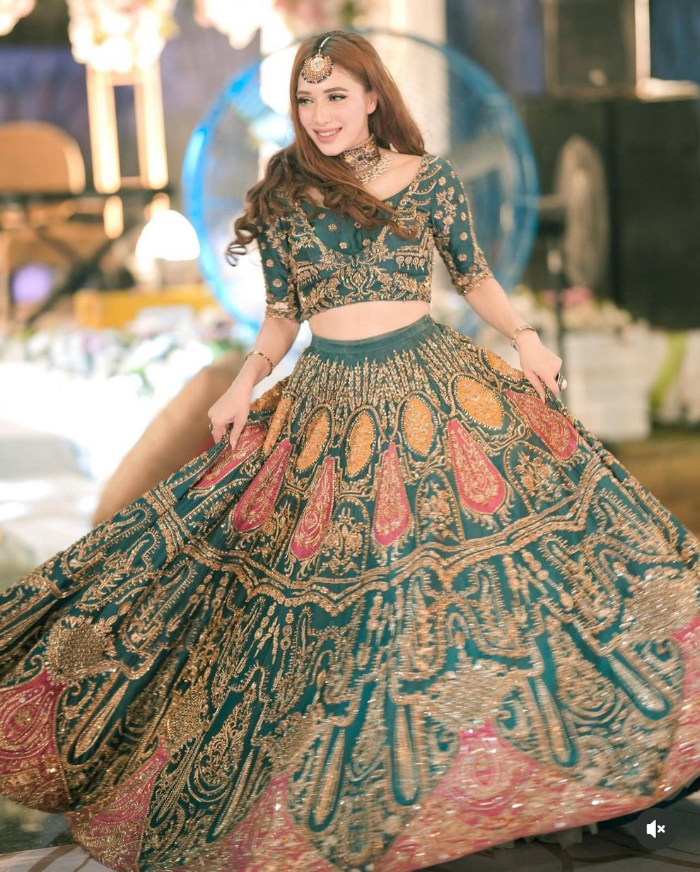 Ahmad Sultan Suraz luxury Pakistani Mehndi outfit featuring an emerald teal embroidered blouse and flowing lehenga