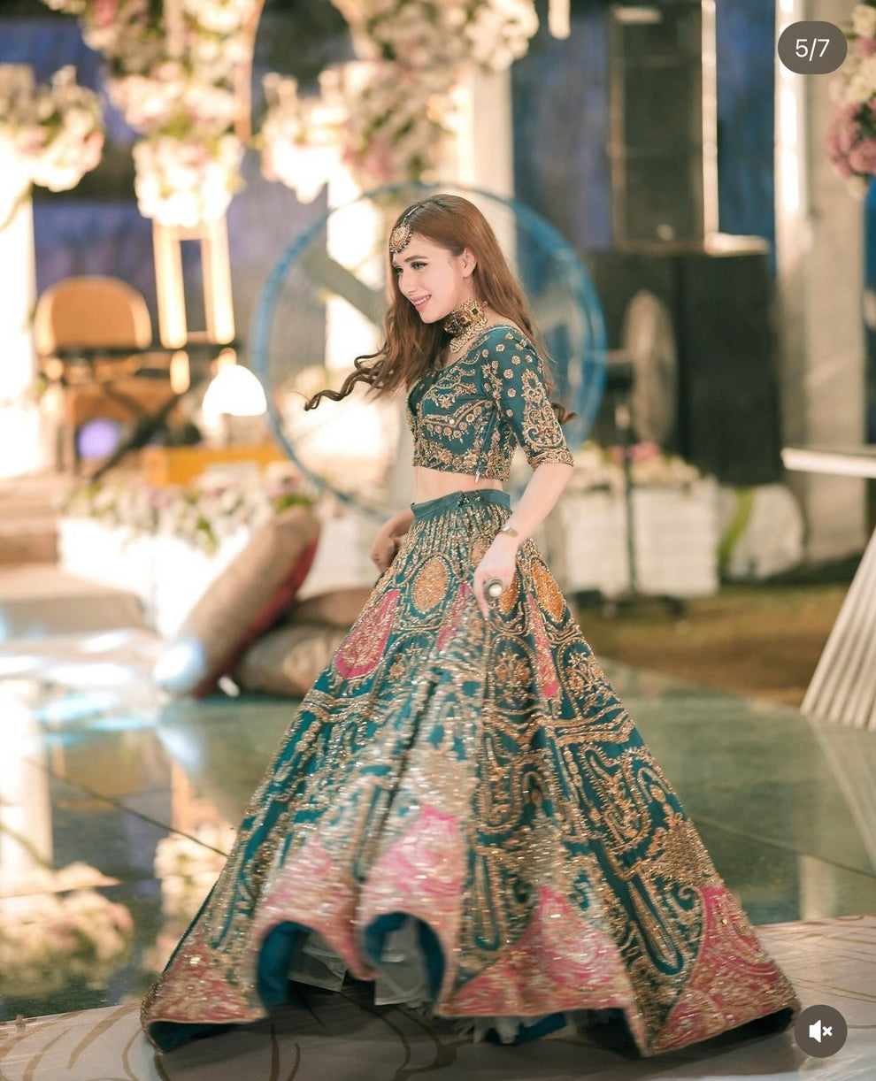 Ahmad Sultan Suraz coordinating organza dupatta styled with an emerald teal Pakistani wedding lehenga