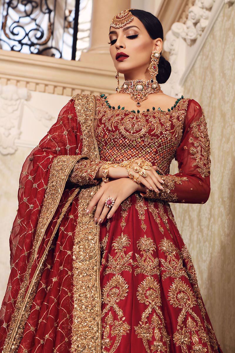 Fahmida Sadaf wearing Aisha Imran Uroos-e-Khas red embroidered bridal lehenga with matching organza dupatta for a Pakistani Baraat wedding