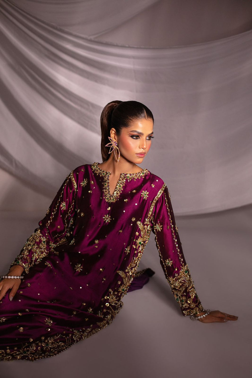 Close-up of antique gold floral embroidery and decorative motifs on Batik Expressive Magenta tassel silk shirt
