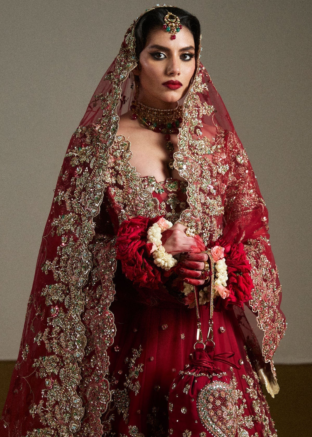 Hussain Rehar Anisha heavily embroidered red bridal lehenga with traditional floral motifs at Zenni’s Atelier
