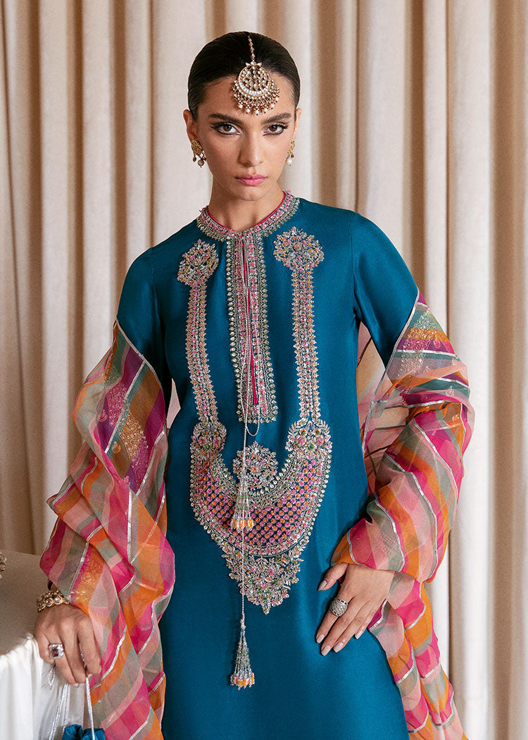 Hussain Rehar Gelid luxury Pakistani formal suit featuring deep teal blue raw silk and colourful embroidered motifs