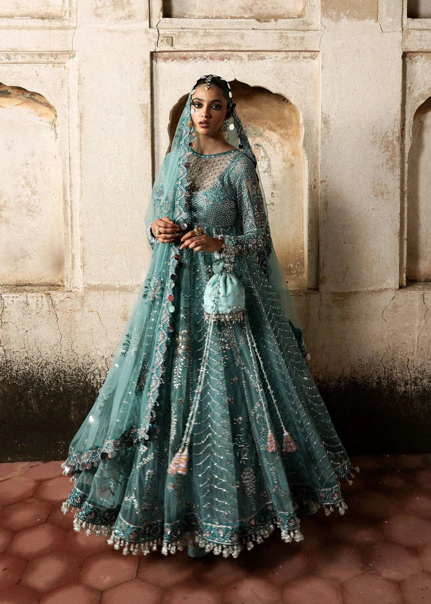 Full-length Hussain Rehar Nagma teal flared pishwas with floral embroidery and decorative hemline at Zenni’s Atelier