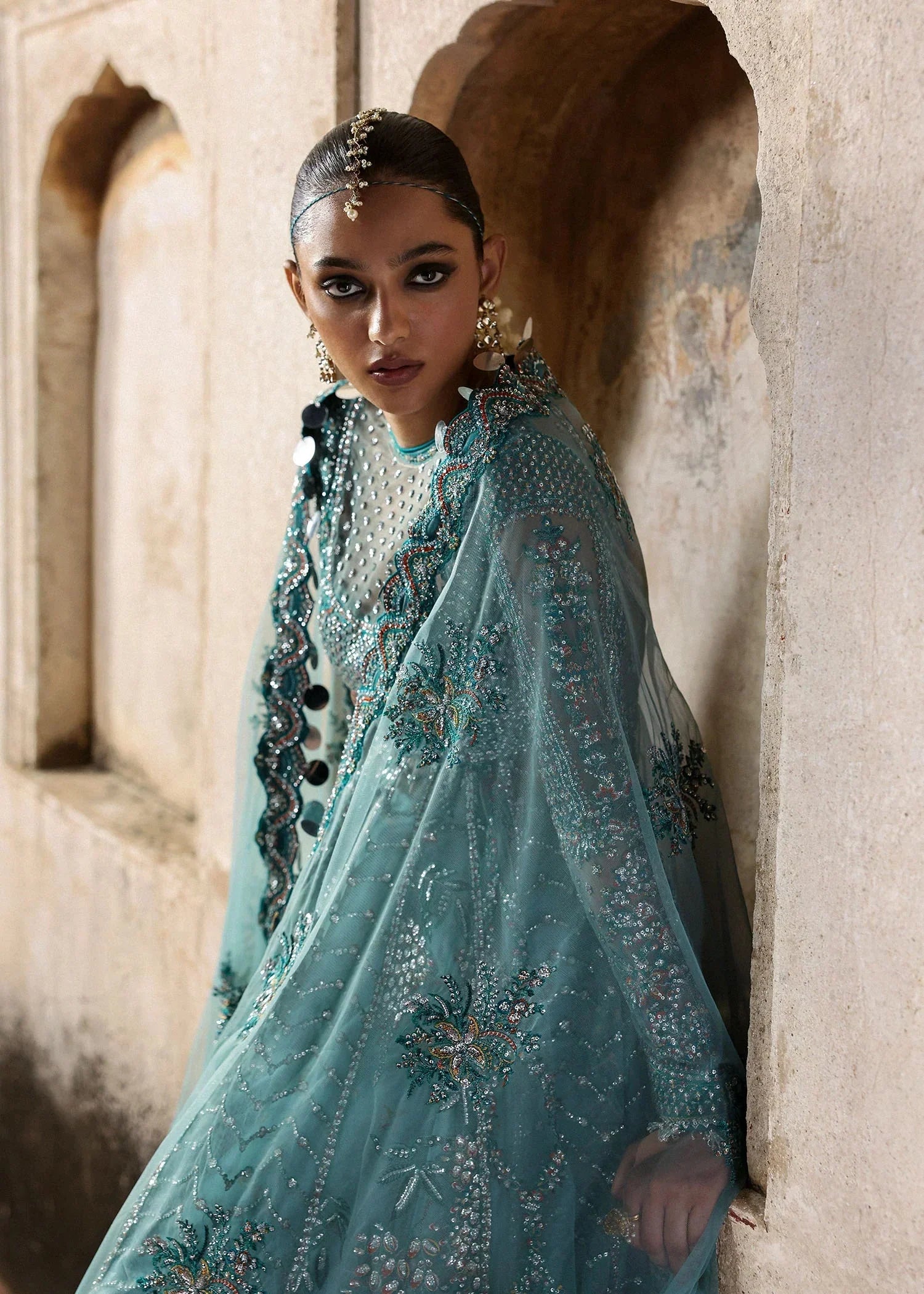 Kiran Malik modelling Hussain Rehar Nagma teal luxury festive dress from Unstitched Festival '25 at Zenni’s Atelier