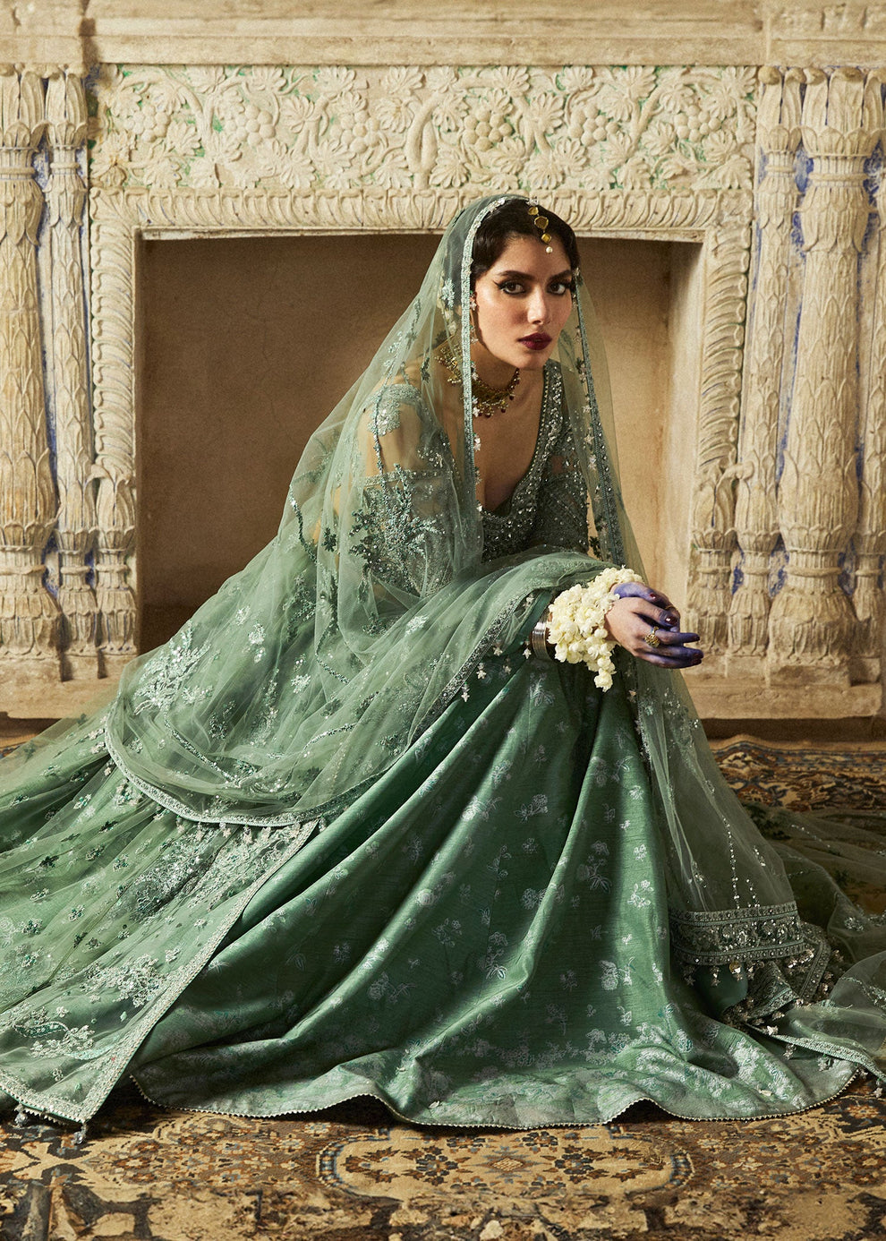 Close-up of intricate silver-toned floral embroidery on Hussain Rehar Parag sage green bridal-inspired outfit