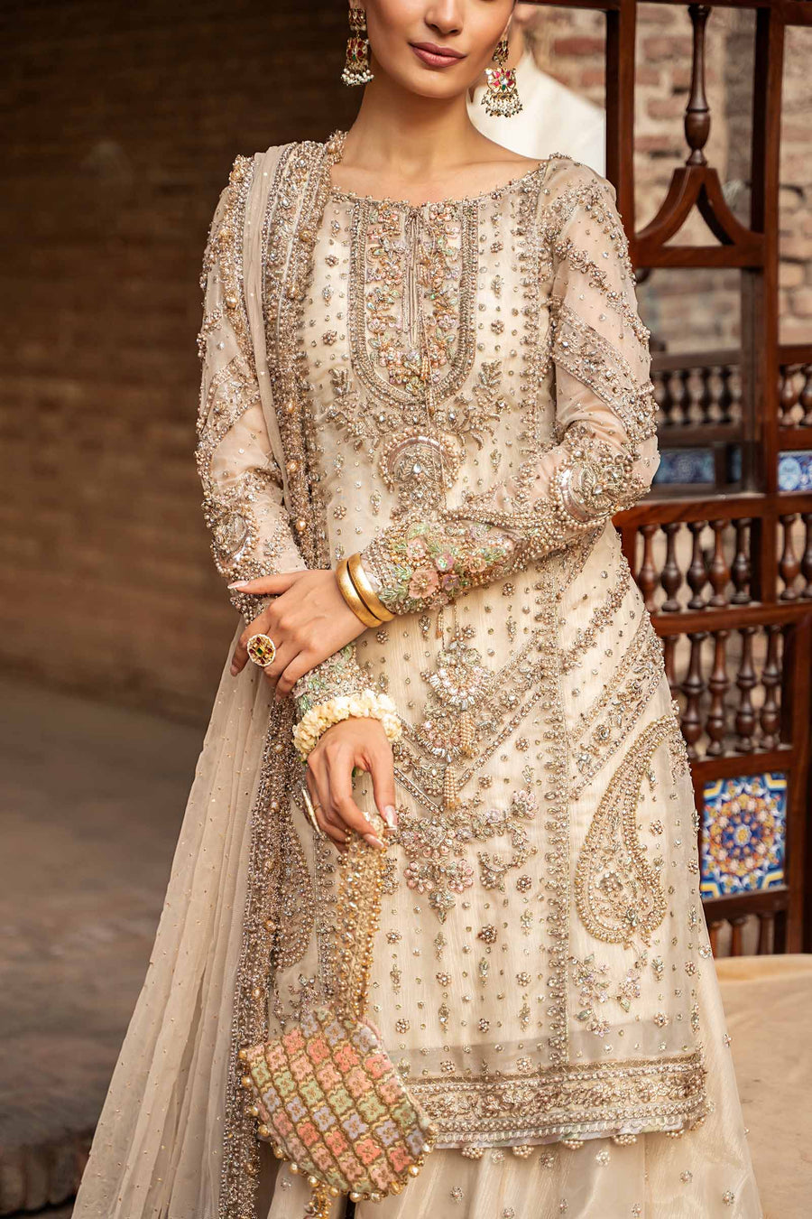 Close-up of intricate antique gold embroidery and decorative neckline detailing on Maria.B Ishtar organza dress