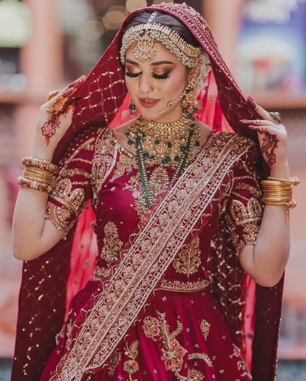 MNR Bridal Ensemble maroon net dupatta with ornate gold embroidered borders at Zenni’s Atelier