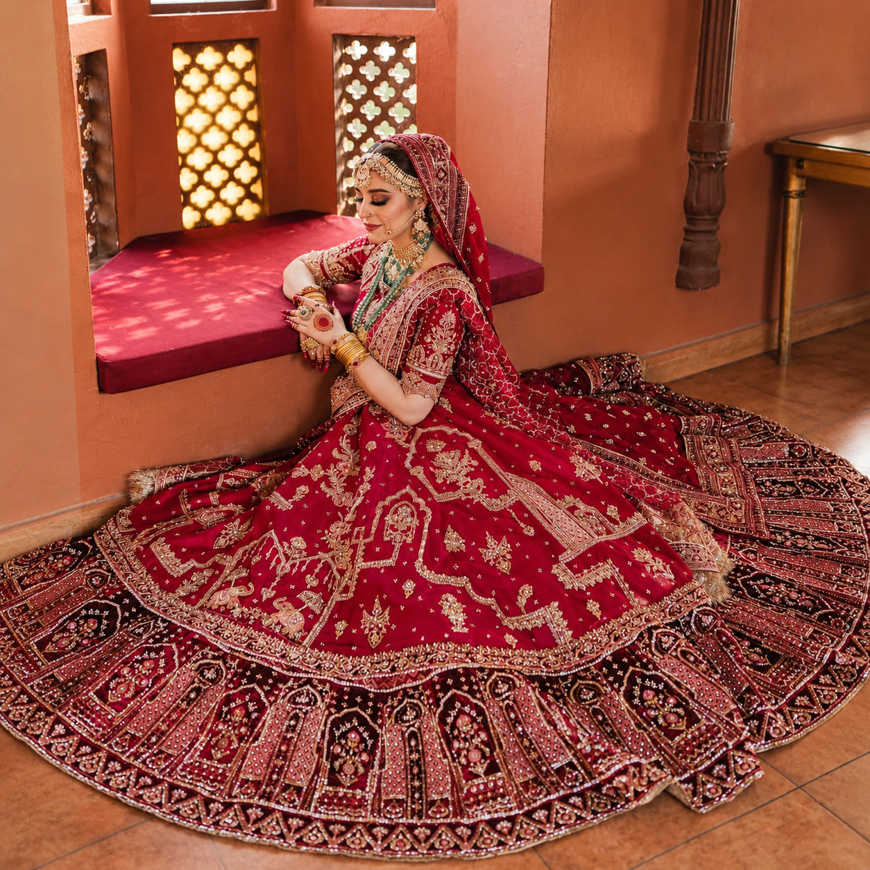 MNR Bridal Ensemble deep maroon and gold embroidered bridal lehenga worn by Rimsha Kiani at Zenni’s Atelier