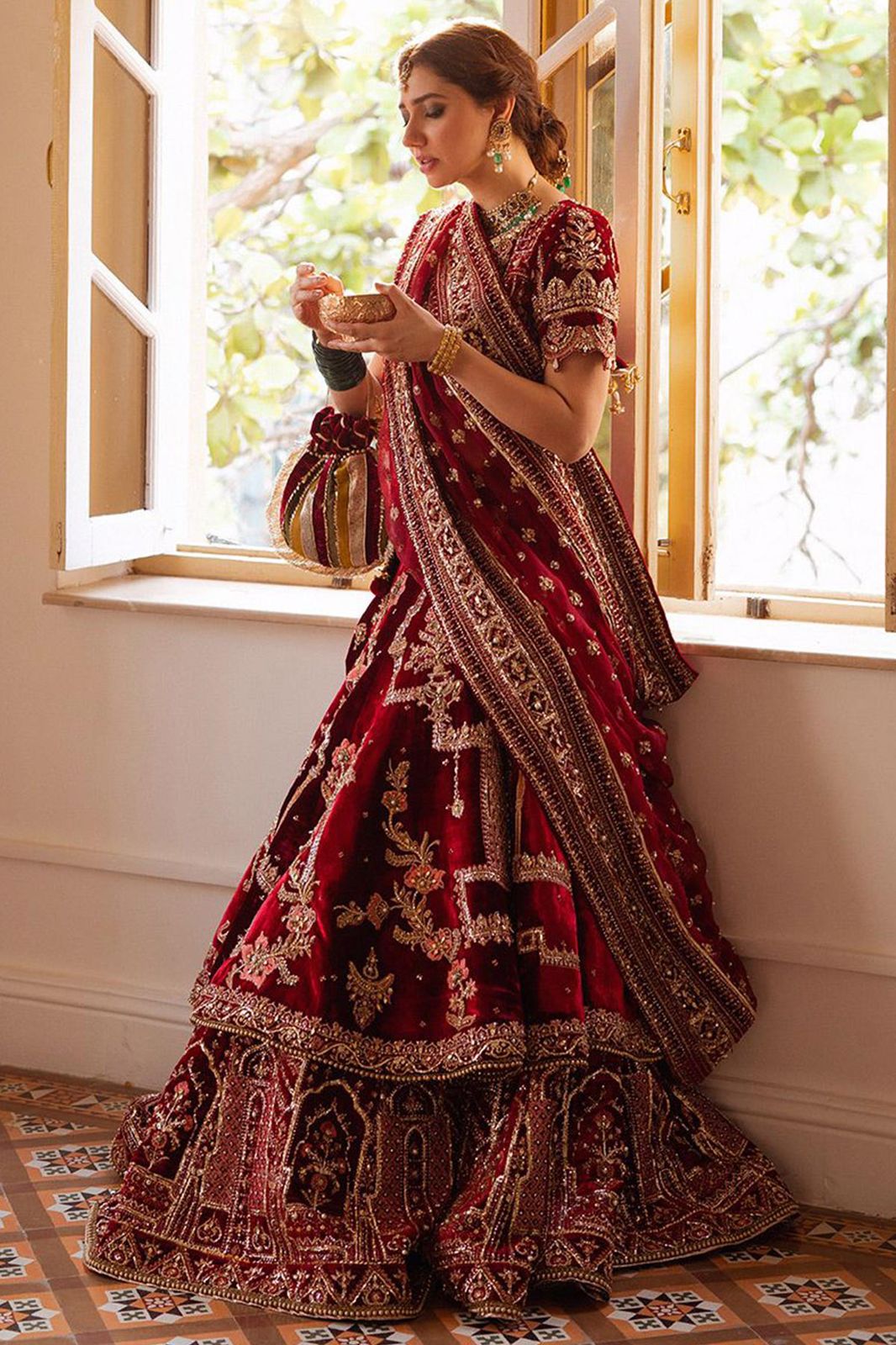 MNR luxury maroon bridal lehenga with traditional gold embroidery for baraat at Zenni’s Atelier