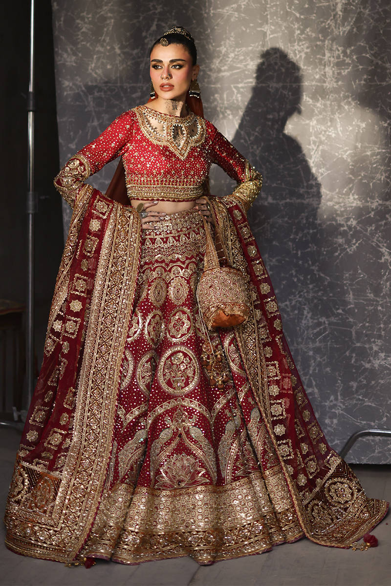 Mohsin Naveed Ranjha Malika Jaan luxury Pakistani Baraat dress featuring crimson red silk and ornate gold embroidery
