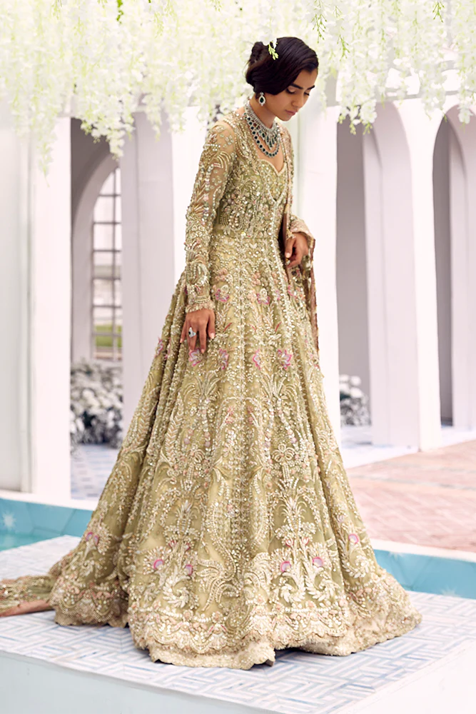 Close-up of intricate champagne gold and blush pink floral embroidery on Suffuse Iris pastel green net bridal dress